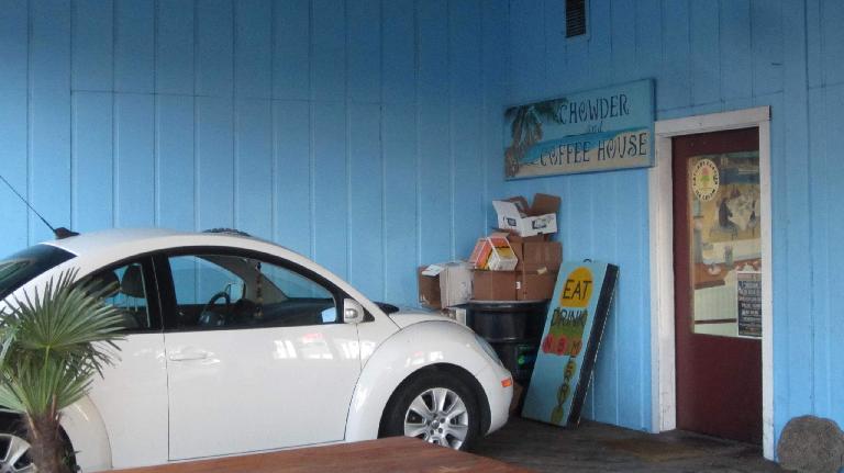 A white Volkswagen New Beetle at the Chowder and Coffee House in Astoria, Oregon. white Volkswagen New Beetle, Chowder and Coffee House, Astoria, Oregon