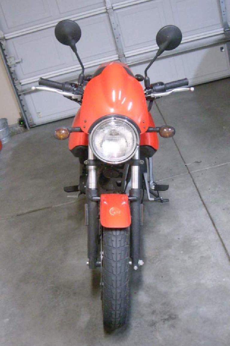 How the handlebars look with the stock mirrors. I would recommend replacing the stock mirrors with bar-end ones -- the stock mirrors don't extend far enough and your shoulders will obscure rear view vision with them. How the handlebars look with the stock mirrors. I would recommend replacing the stock mirrors with bar-end ones -- the stock mirrors don't extend far enough and your shoulders will obscure rear view vision with them.
