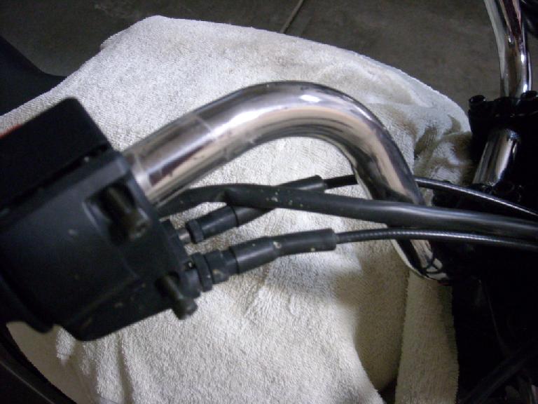 Unscrewing the two SAE screws to detach the throttle assembly. Unscrewing the two SAE screws to detach the throttle assembly.