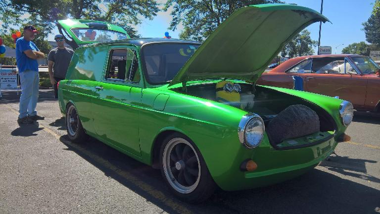 A custom green Volkswagen two-door wagon with a minion inside the front trunk. A custom green Volkswagen two-door wagon with a minion inside the front trunk.