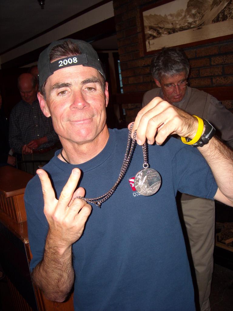Eddie with Frank's 1976 silver medal from the Olympic marathon. Eddie with Frank's 1976 silver medal from the Olympic marathon.