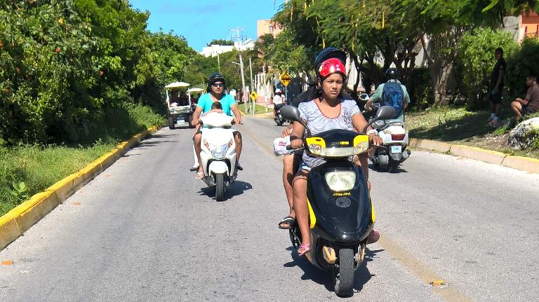 Mexicans driving motorbikes in Isla Mujeres. Mexicans driving motorbikes in Isla Mujeres.