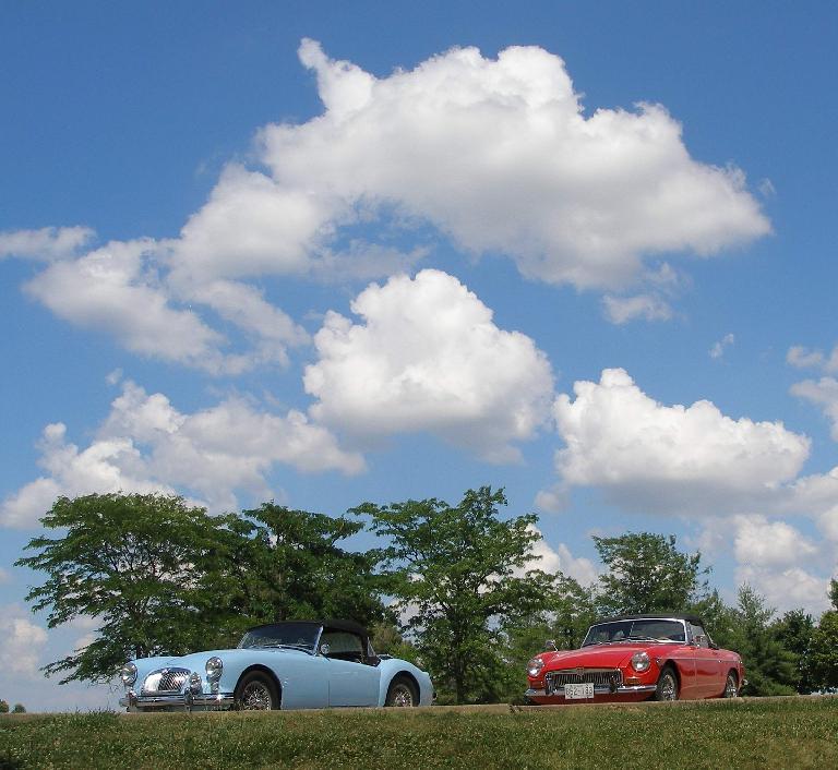 Mike Jacobsen's light blue MGA and Jennifer Orum's red 1970 MGB below some puffy clouds at the Wright City rest stop off I-70. Photo: Mike Jacobsen. (June 19, 2016) Mike Jacobsen's light blue MGA and Jennifer Orum's red 1970 MGB below some puffy clouds at the Wright City rest stop off I-70. Photo: Mike Jacobsen. (June 19, 2016)