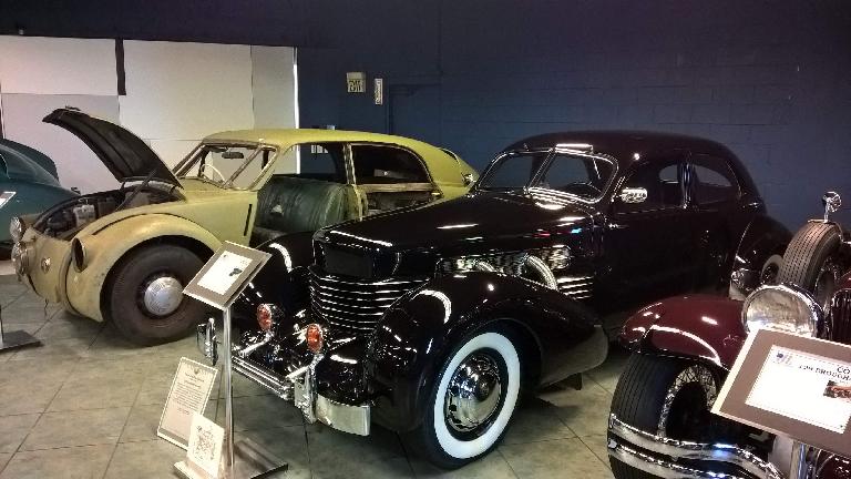A black 1937 Cord 812 front wheel drive car with supercharger and rectractable headlights in the front fenders. A black 1937 Cord 812 front wheel drive car with supercharger and rectractable headlights in the front fenders.
