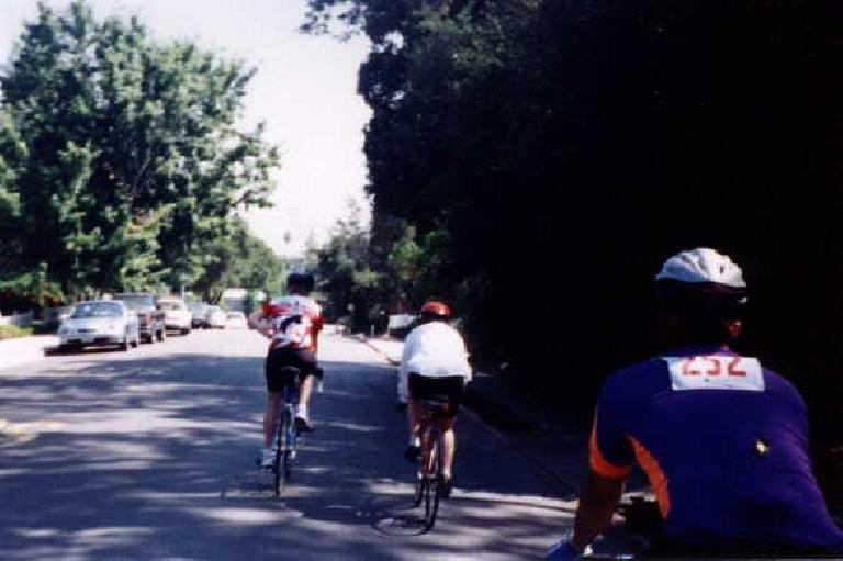 Three Stanford cyclists ride through Saratoga during the 1998 Tour du Jour. three Stanford cyclists, Saratoga, 1998 Tour du Jour