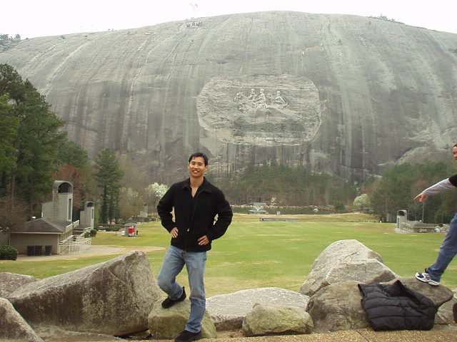 Felix Wong in front of the carving of Stonewall Jackson, Robert E. Lee and Jefferson Davis, which is supposedly 3X larger than the carving in Mt. Rushmore.
