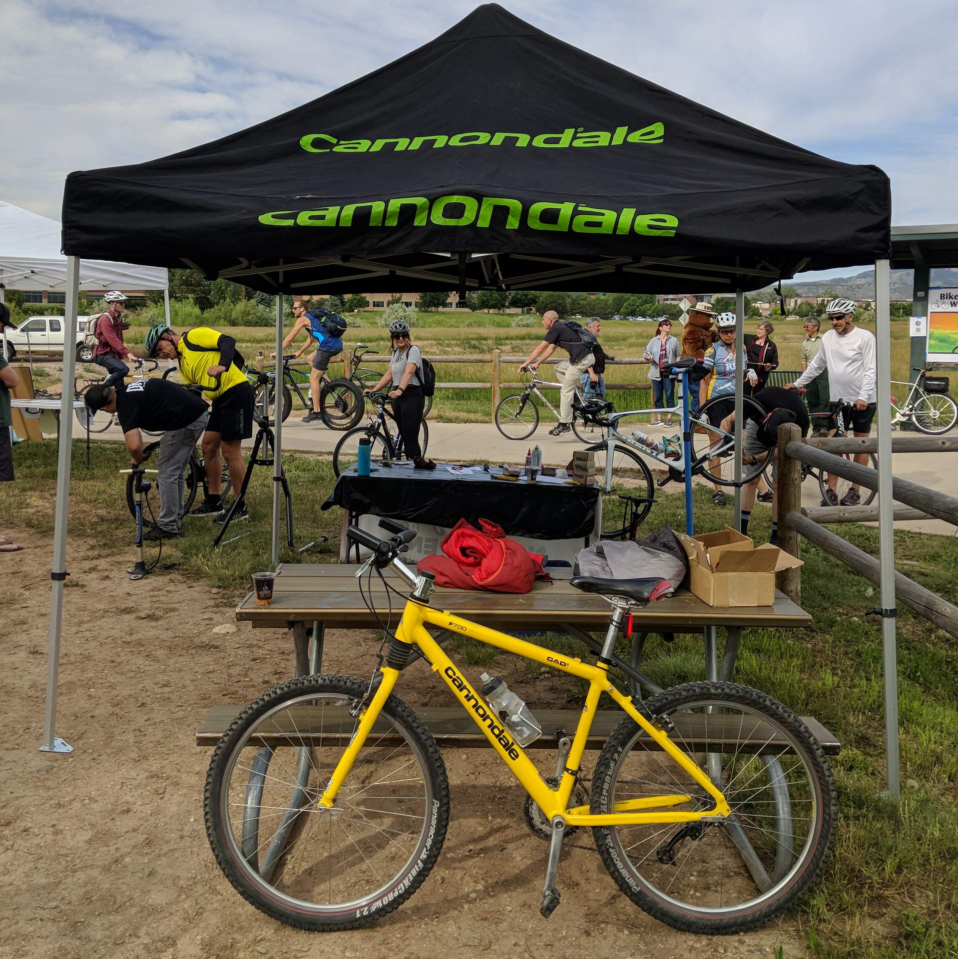 My yellow 1996 Cannondale F700 in front of a Cannondale tent.