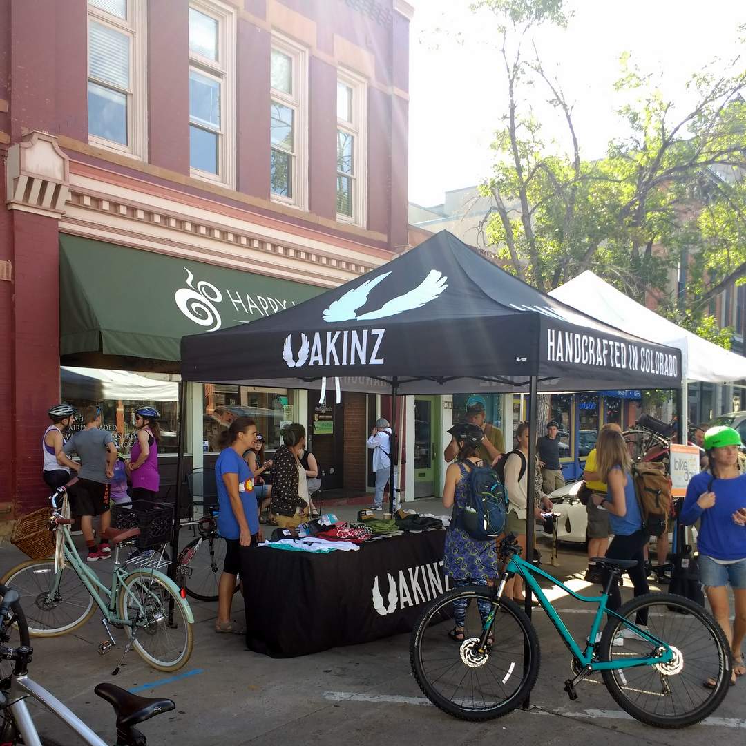 The Fort Collins Bike to Work Day station, in front of Happy Lucky's Tea House.  Akinz clothing and the Fort Collins Bike Co-op staffed it.