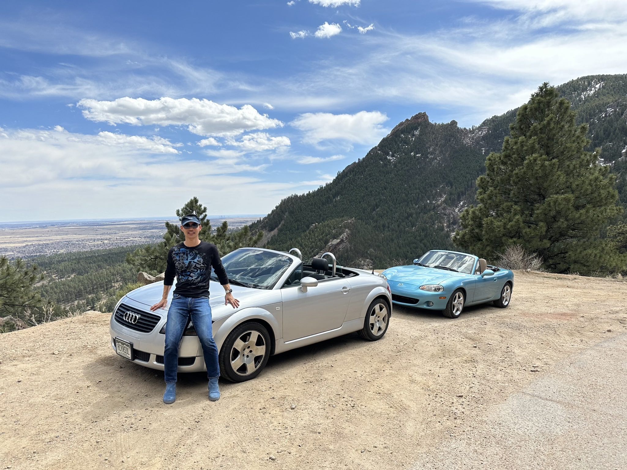 Felix Wong with his silver Audi TT Roadster Quattro Roadster at an overlook on Flagstaff Road west of Boulder, Colorado. Manuel's crystal blue metallic Mazda Miata is behind.
