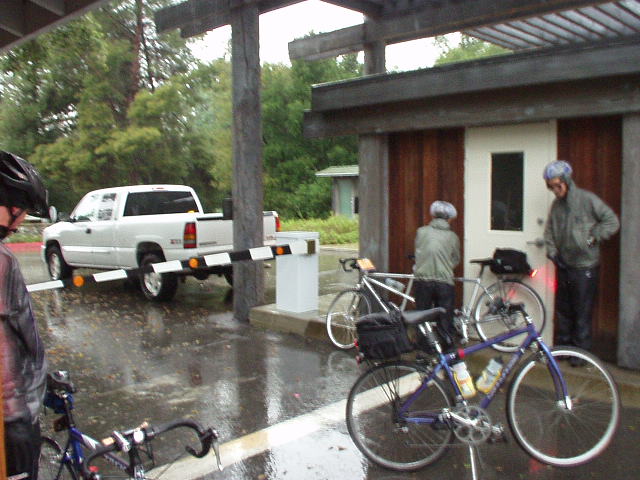 [Mile 26, 6:59 a.m.] Other riders at the first checkpoint, standing out of the rain wondering what I was thinking: is Planet Ultra going to arrive with some food?