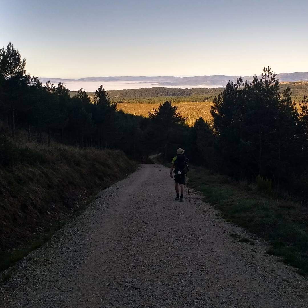 A peregrino walking along the Camino Primitivo on the border of Asturias and Galicia.