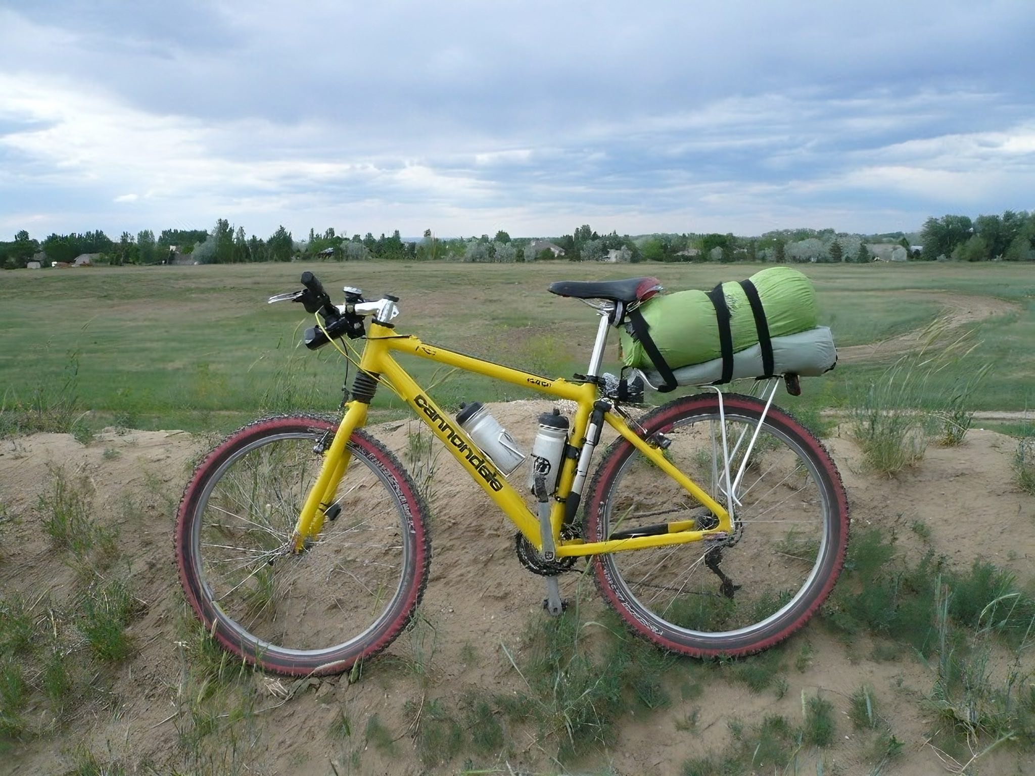 My Speed Yellow 1996 Cannondale F700 CAAD3 mountain bike in the field behind my house in Fort Collins, all prepared for the 2008 Tour Divide bikepacking mountain bike race.
