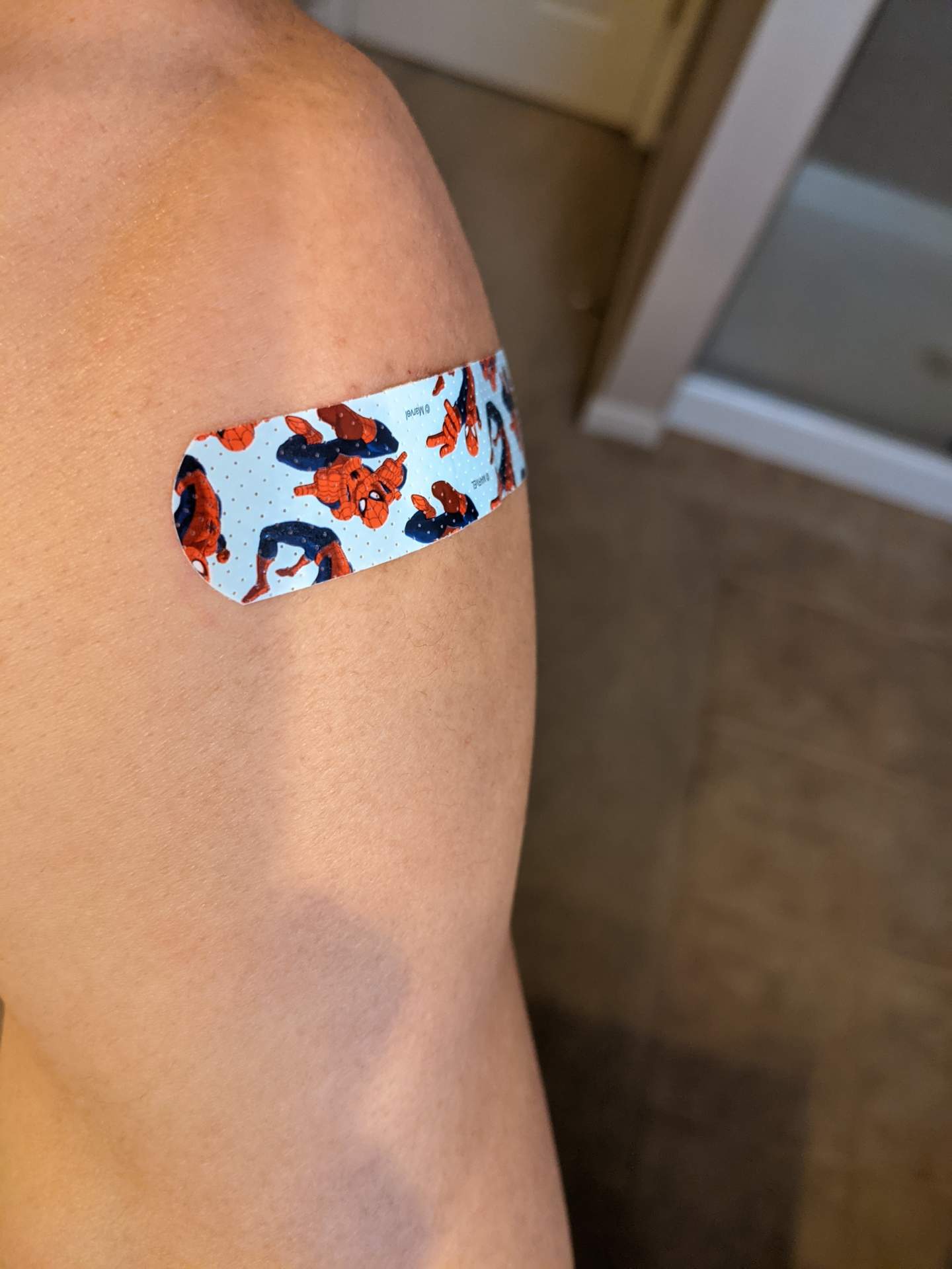 left arm with Spiderman bandage