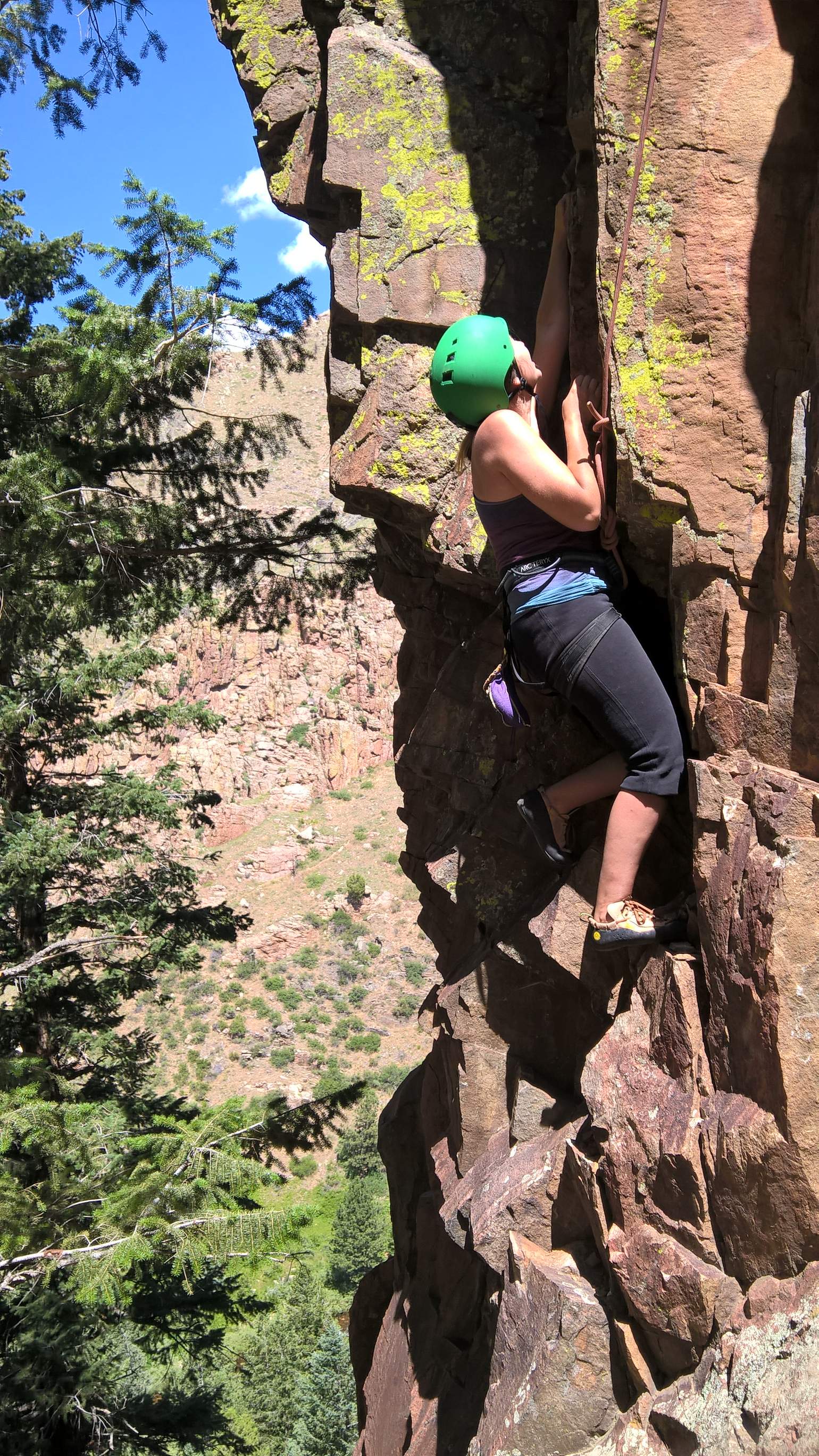 Diana climbing County Line (5.8) in the Southwest Alcove of Crystal Wall.