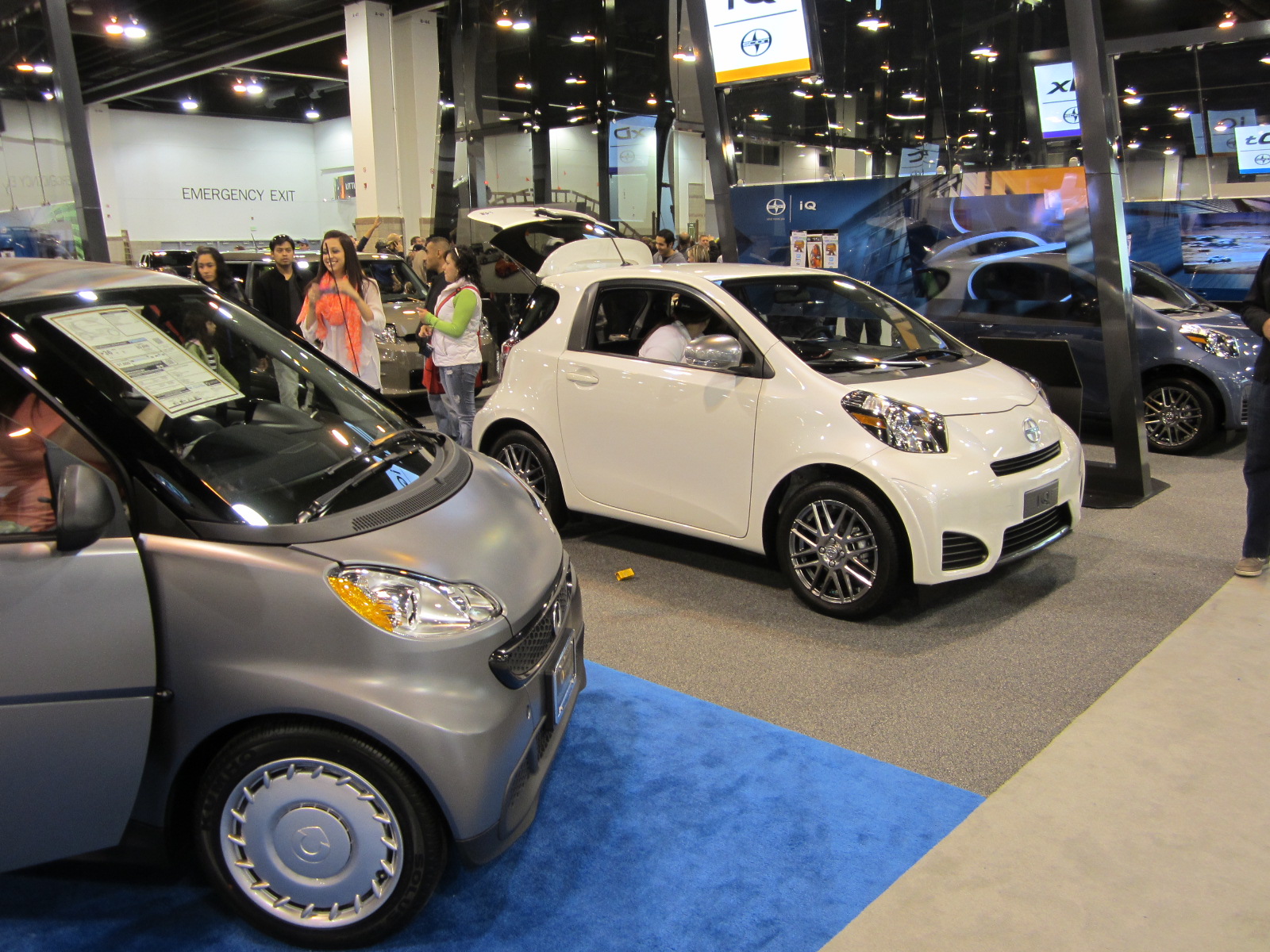 A Smart "pure coupe" (left) and two Scion IQs (center and right).