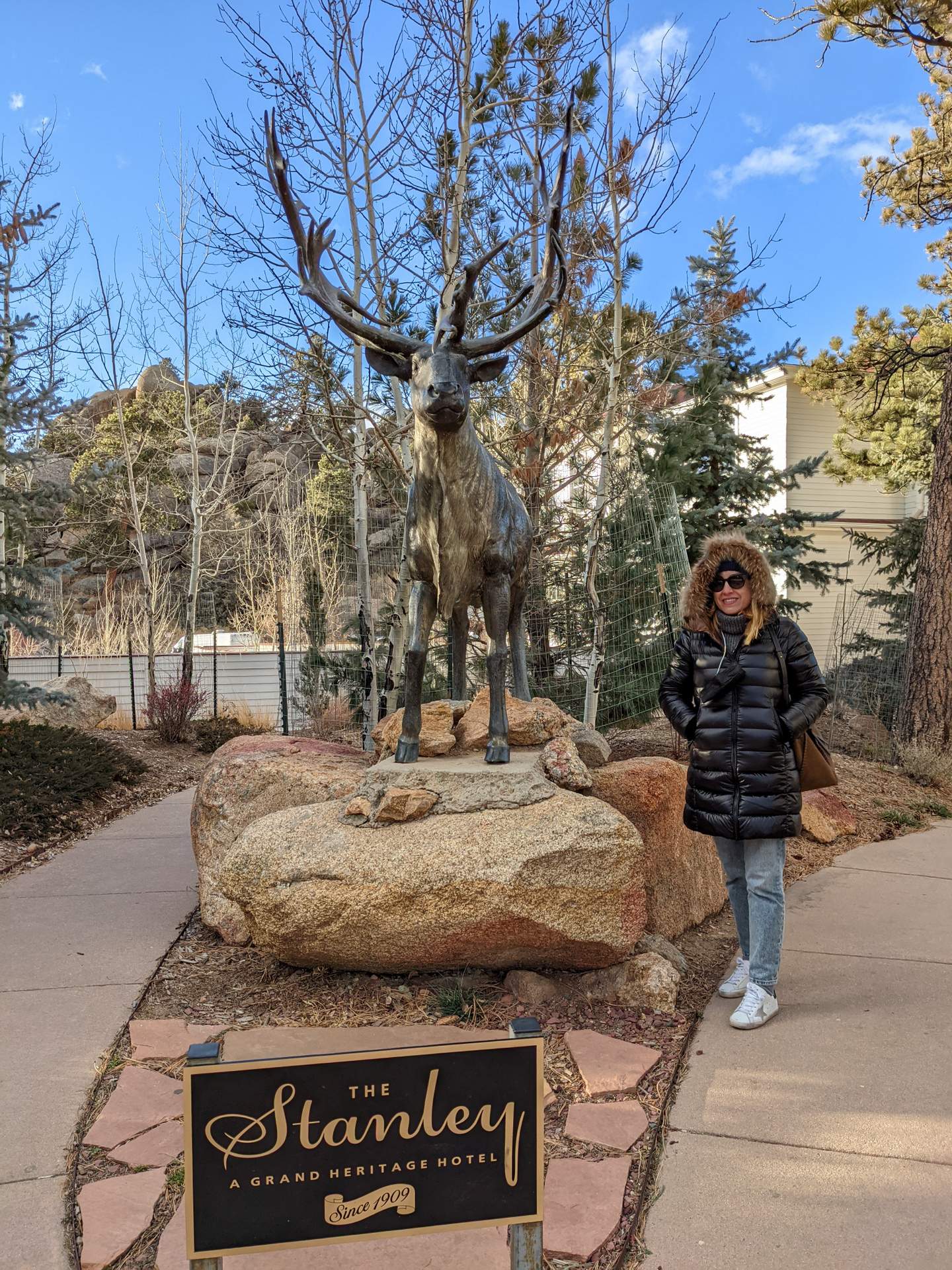 Andrea with a statue of a deer outside the Stanley Hotel.