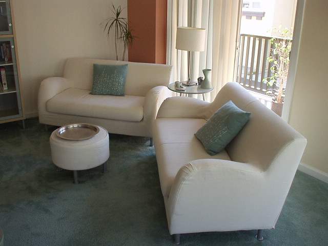 Felix Wong townhouse, living room, Fremont, two white Ikea love seats, white Ikea ottoman, silver platter