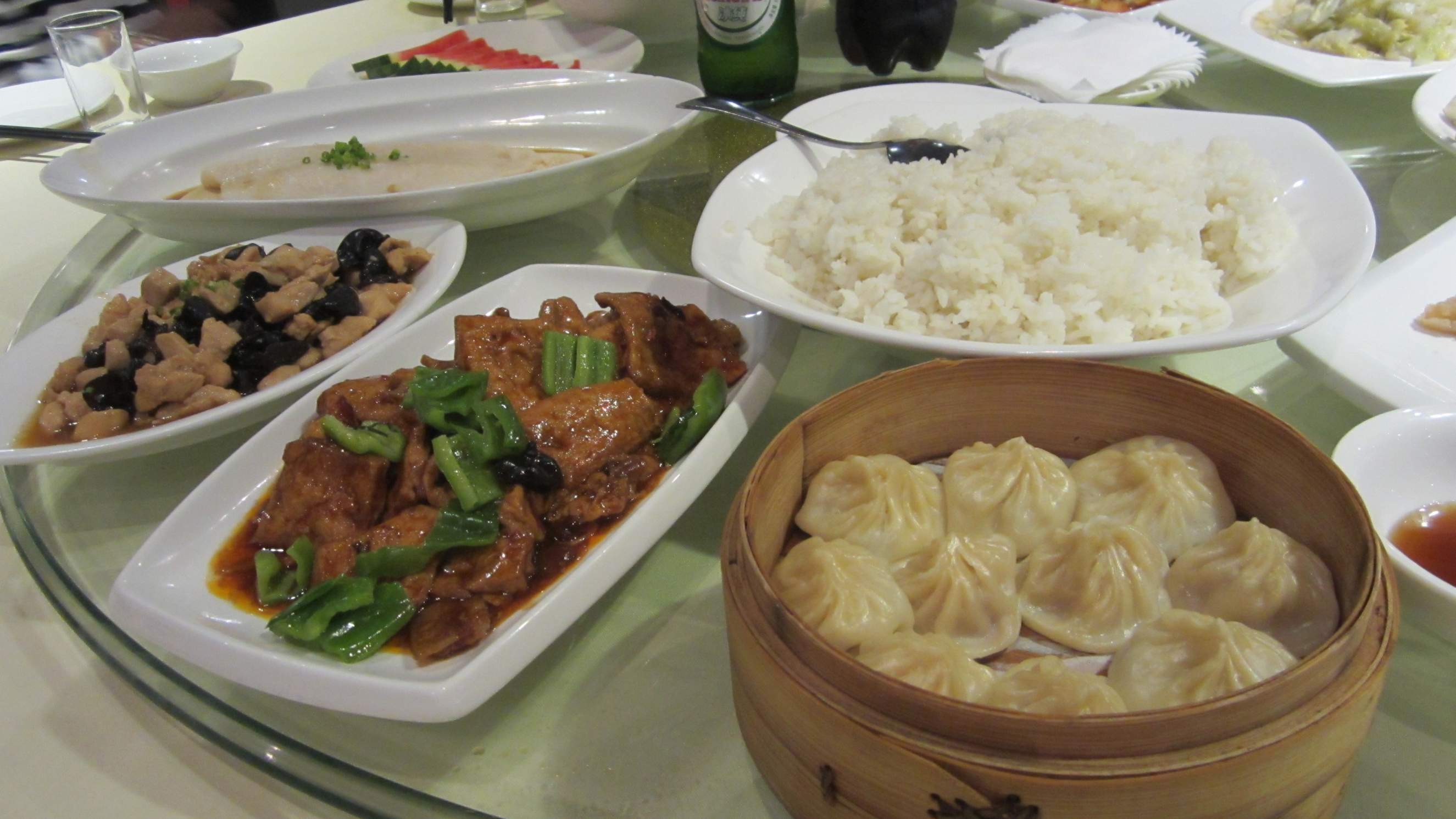 Lunch in Shanghai: fish, chicken and bell peppers, white rice, and Xiaolongbao dumplings.