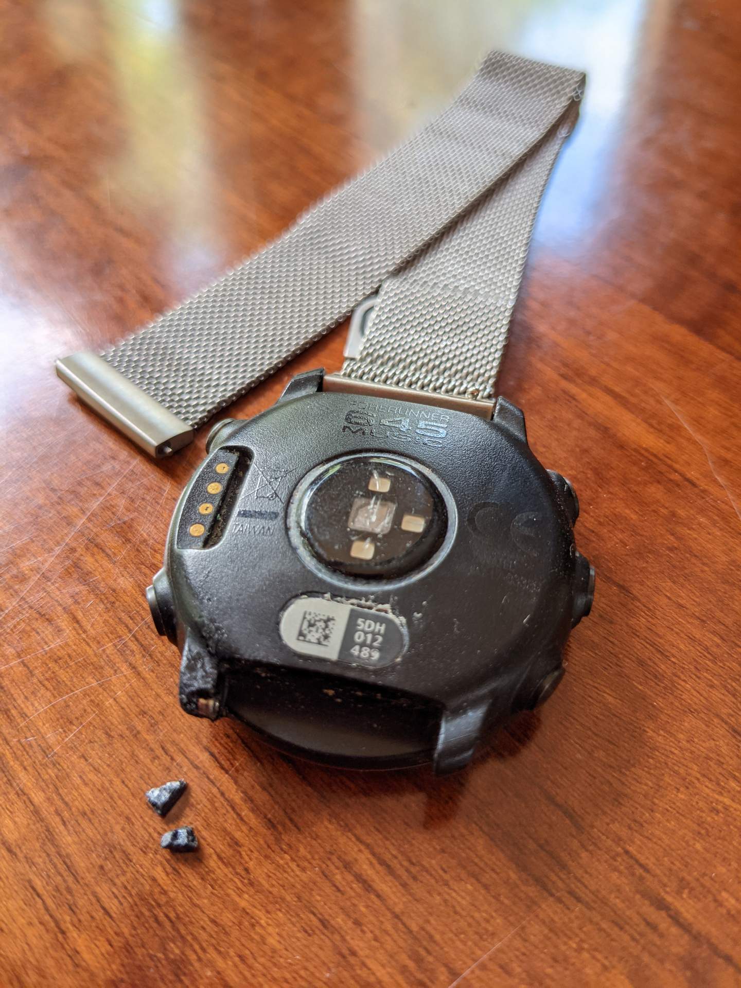 A not-uncommon problem with Garmin watches is the watch pin supports (what I call "ears") breaking. The watchband pulls out of the watch. Here, I had re-inserted and Super Glued the watch pin "collar" into the watch.