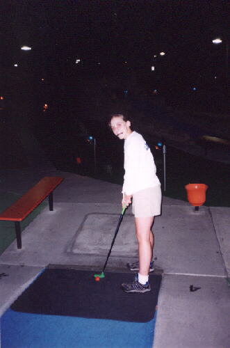 ... and even look cute with glasses and a pencil in her mouth.  Here Cathy gets ready to putt.