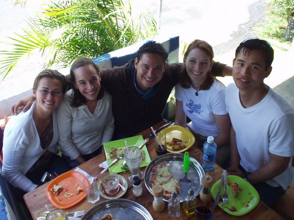 four young people gathered around a table to each lunch in Boquete, Panama