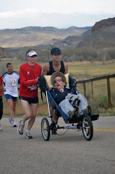 Dan J. (red), Nick (stroller) and me running up Bingham Hill in the Horsetooth Half Marathon for Athletes in Tandem.