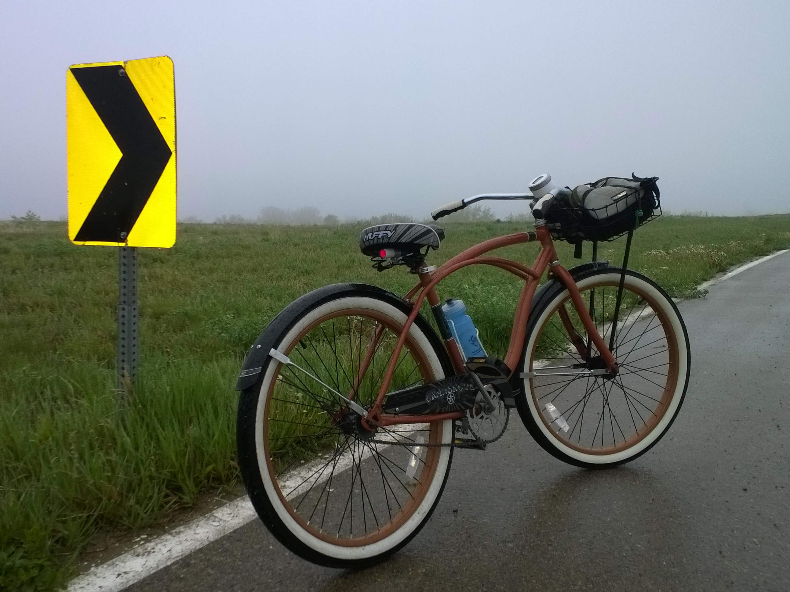 My bronze 2012 Huffy Cranbrook cruiser did well on this rainy day with stock fenders and an added-on tail light and handlebar basket.