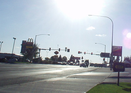 wide road with few cars and traffic lights