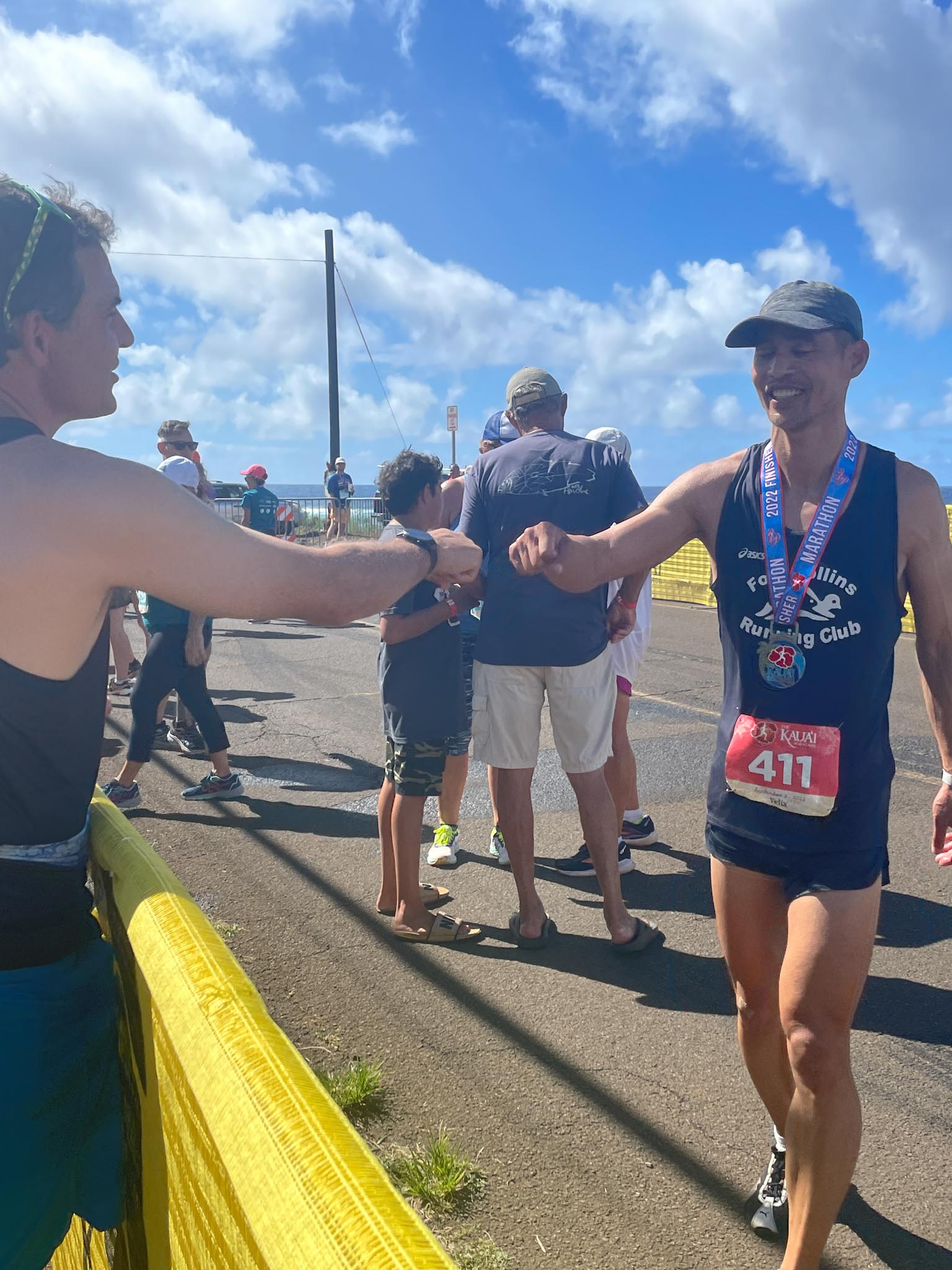 Dave fist-bumps Felix at the end of the 2022 Kauai Marathon.