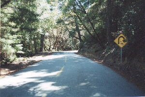 Kings Mountain Rd., yellow sign with sharp right turn indicated