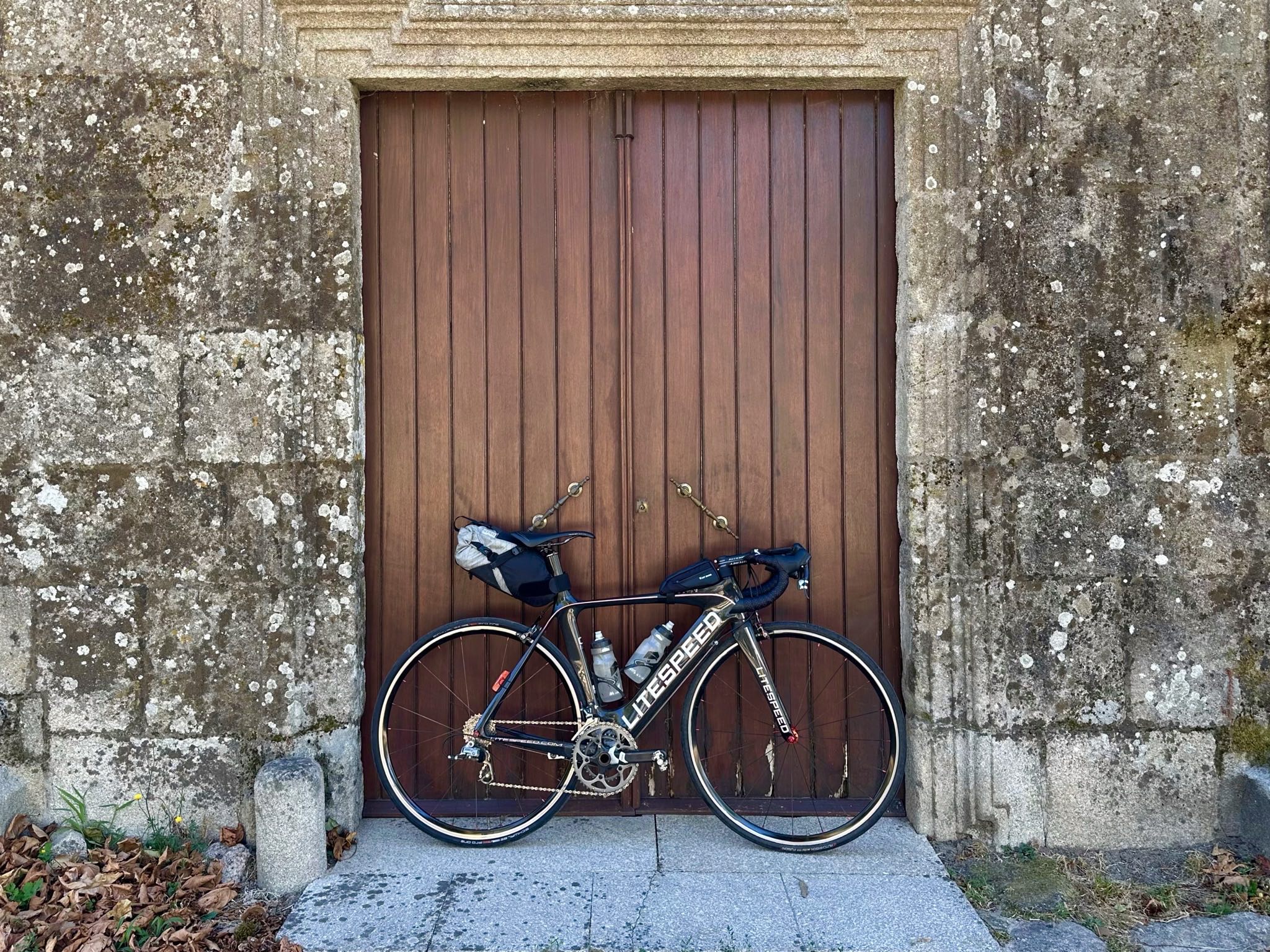 My Litespeed Archon C2 with bikepacking gear for London-Edinburgh-London in front of a wooden door at an old church. (30 Jul 2025) My Litespeed Archon C2 with bikepacking gear for London-Edinburgh-London in front of a wooden door at an old church.
