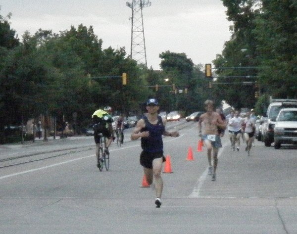 Felix Wong, a shirtless runner, and more runners behind on coned street