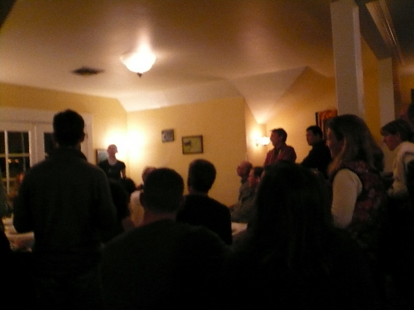 many people in a poorly lit room listening to mountain running seminar
