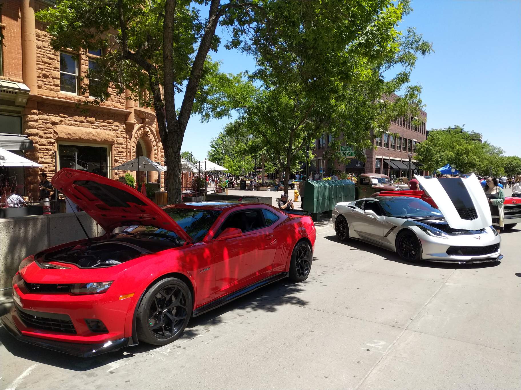 Modern muscle: a red Chevrolet Camaro and seventh-generation Corvette.