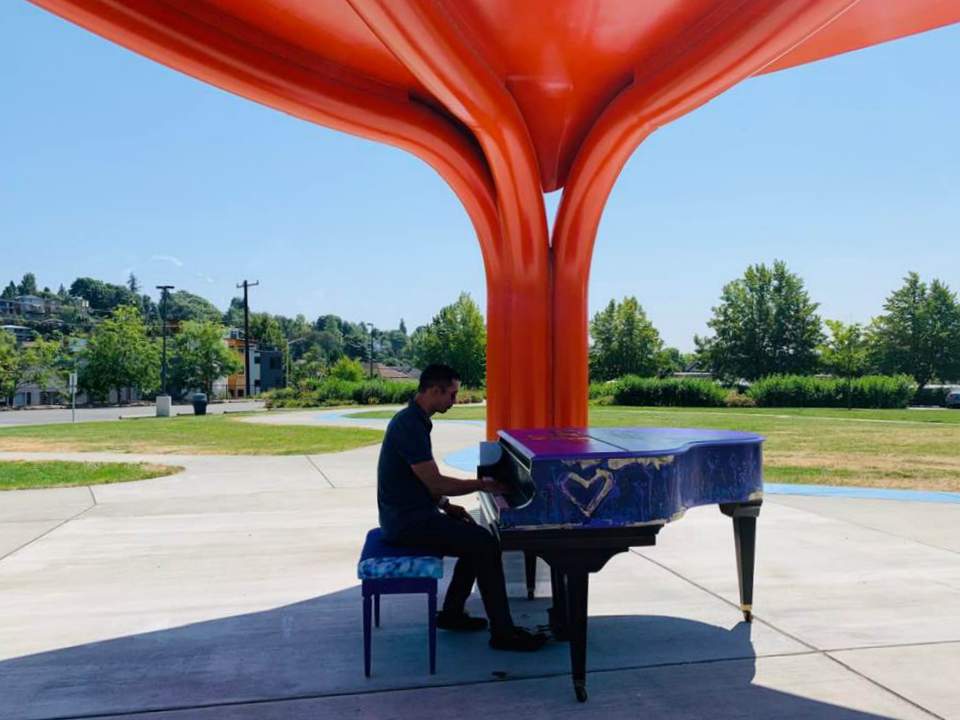 Felix Wong playing the piano at Jimi Hendrix Park in Seattle.