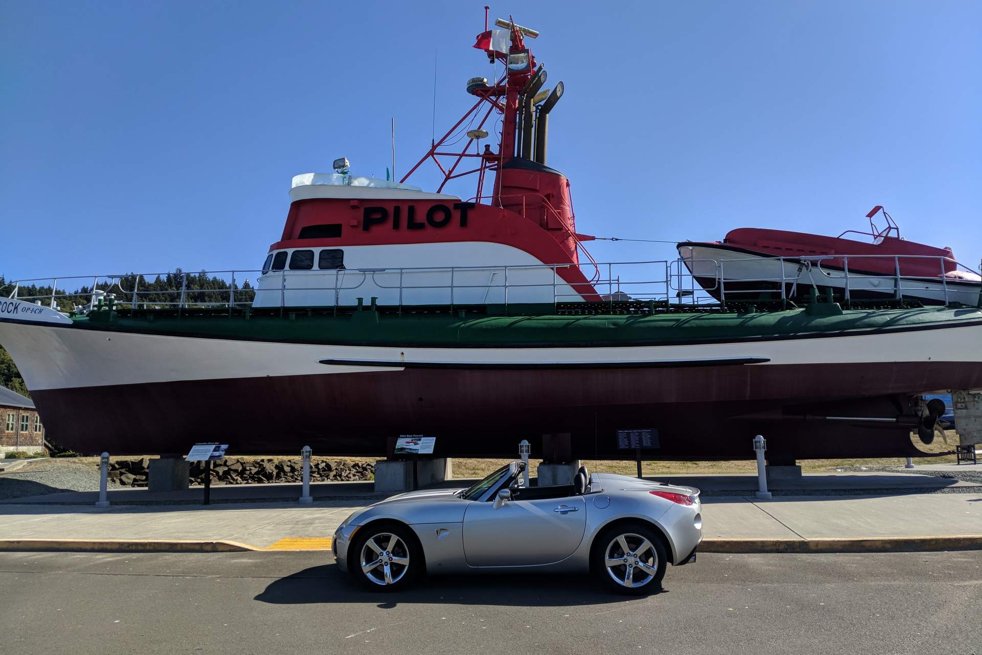 Silver Pontiac Solstice GXP in front of a Pilot ship in Astoria, Oregon.