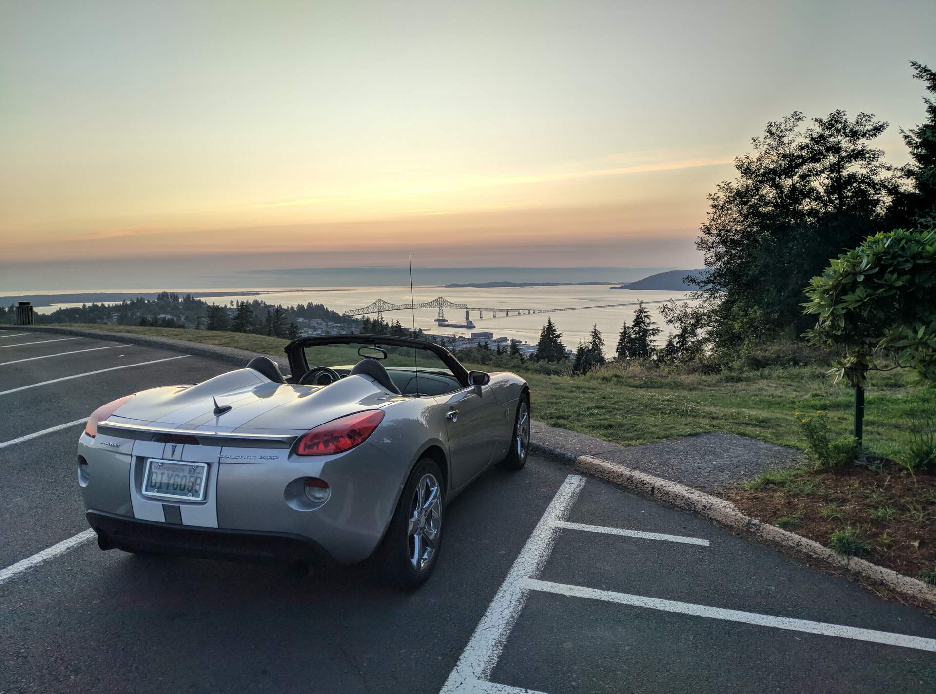 silver Pontiac Solstice GXP, sunset, US-101 bridge