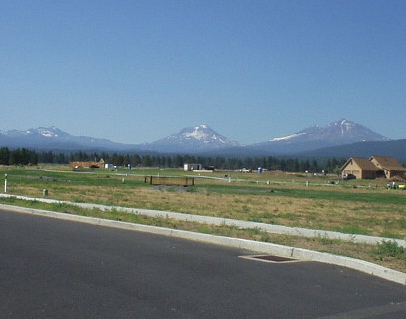 The Three Sisters looming over rural homes in Sisters, Oregon.