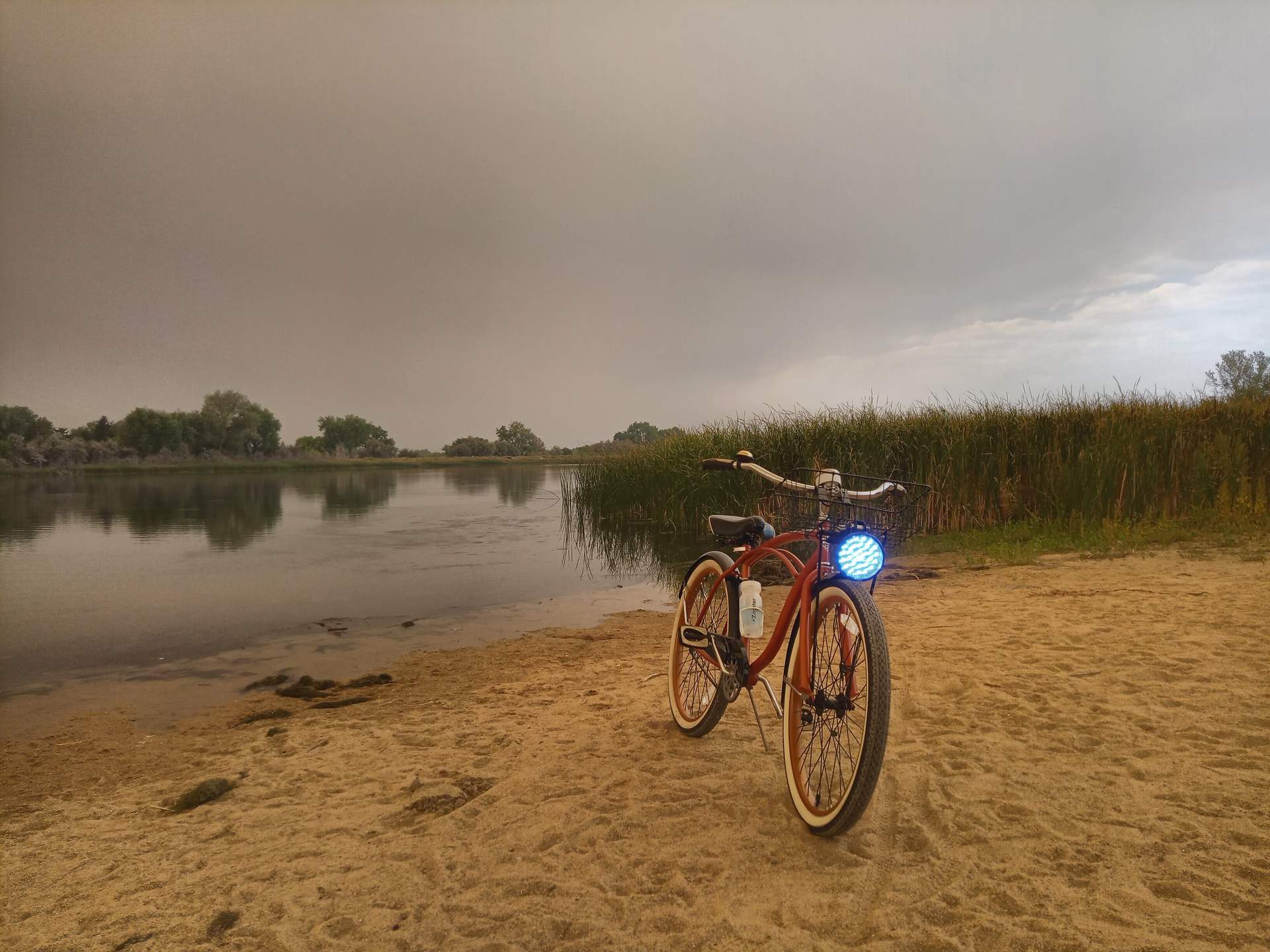 My Huffy Cranbrook cruiser bike at the neighborhood lake with dark smoke lingering above.