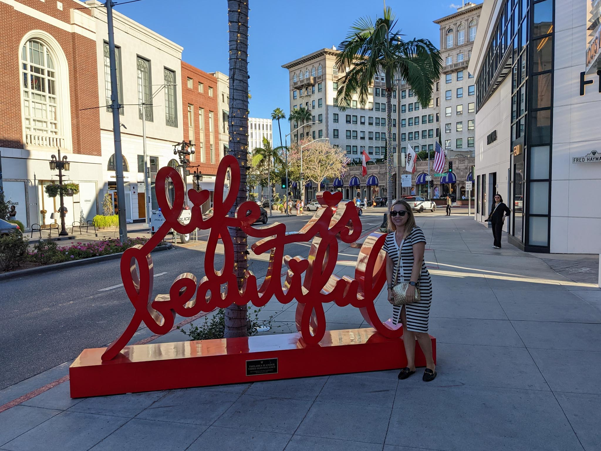 Andrea by the red Life is Beautiful sign on Rodeo Drive in Beverly Hills.