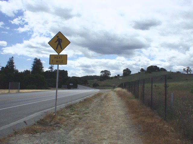 [Mile 28.7, 12:08 p.m.] The half-mile before hitting Junipero Serra, my right knee started giving me intermittent problems, but managed not to look entirely like this sign (walking).  Still, I couldn't help but think, "I want my bike"