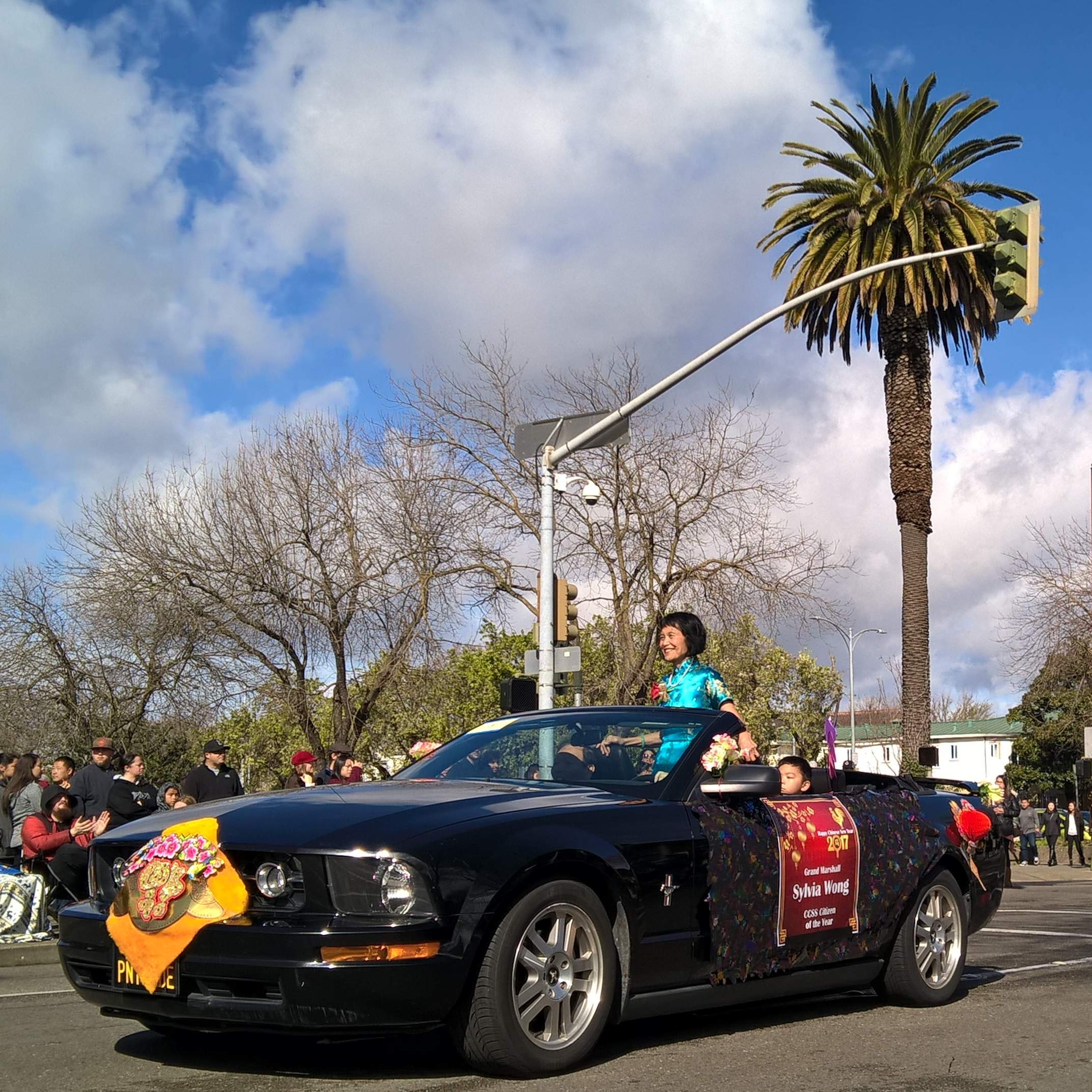 Sylvia Wong, Citizen of the Year, in the black Mustang convertible used in the 2017 Stockton Chinese New Year parade.