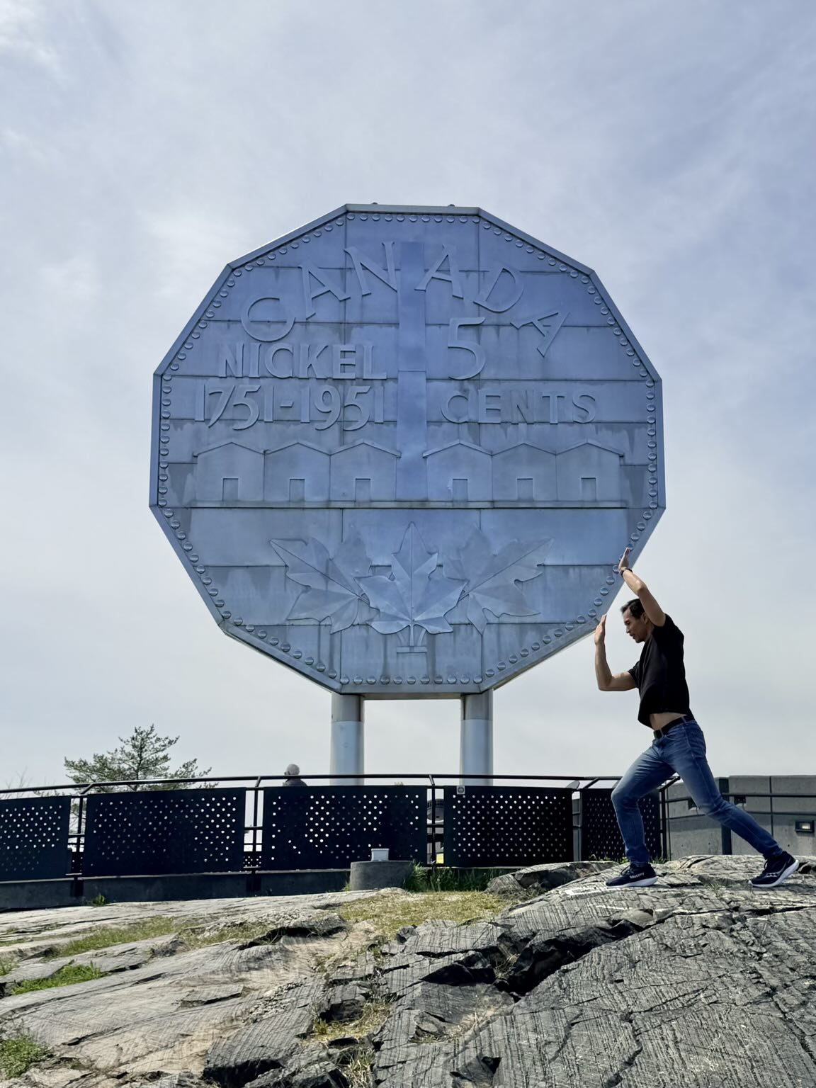 Felix pretending to be pushing the Big Nickel in Sudbury.