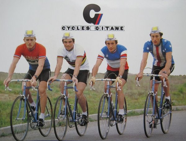 For most of his Tour de France victories, Bernard Hinault (second from the left) rode a Gitane.  This postcard is probably from around 1980.