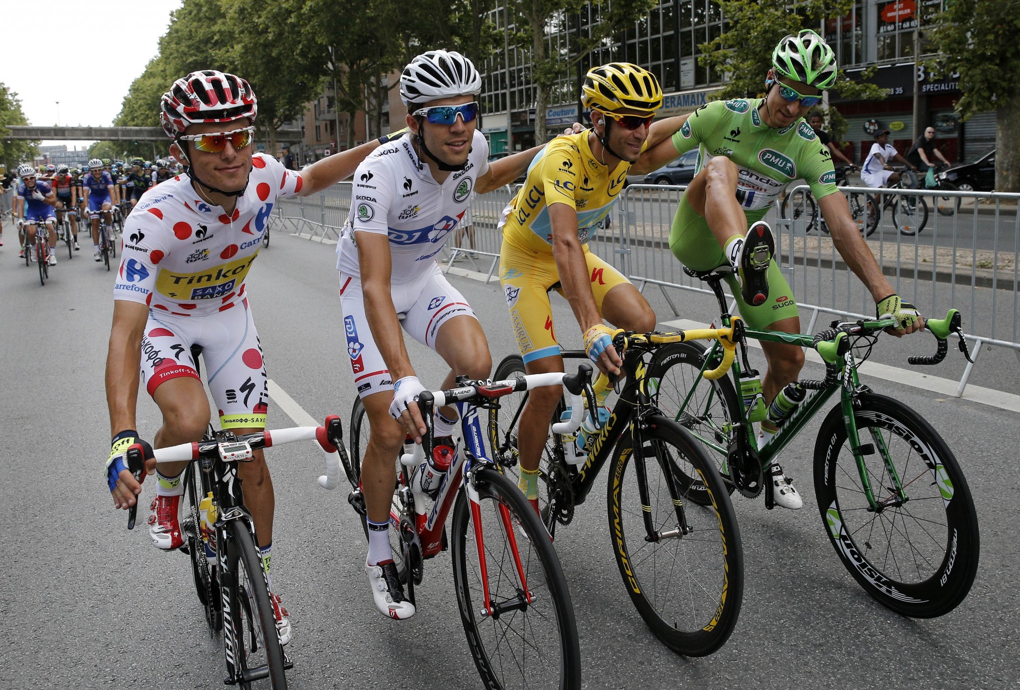 Vincenzo Nibali (in yellow) on a Specialized Tarmac during the final stage of the 2014 Tour de France. Other riders are Rafal Majka (best climber), Thibaut Pinot (best young rider), and Peter Sagan (best sprinter).