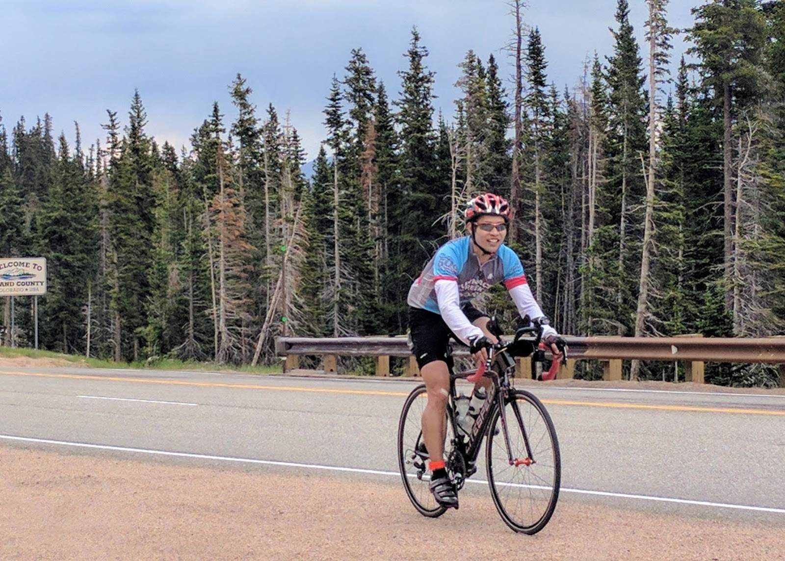 Felix Wong riding a black 2010 Litespeed Archon C2 over the summit of Berthoud Pass, Colorado.