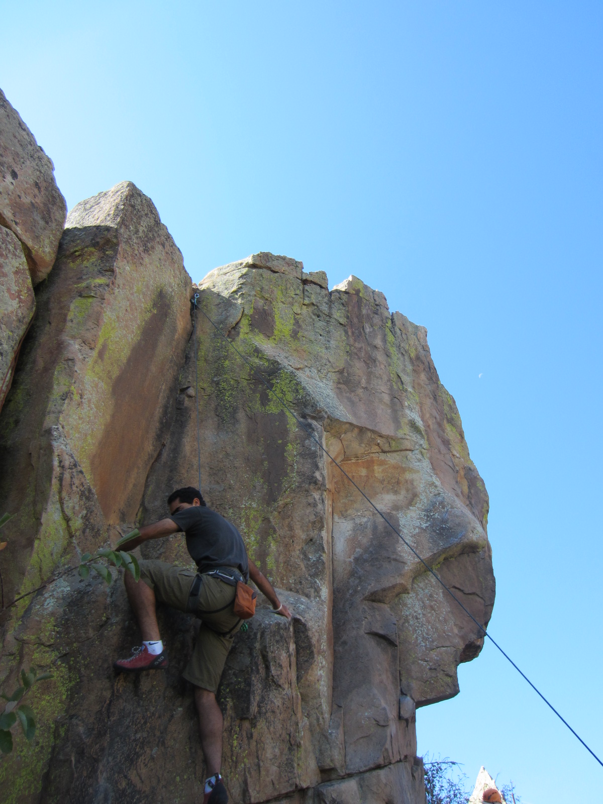 Mehdi climbing over a ledge that lead to a crack climb at the Torture Chamber.