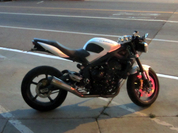 A Triumph Street Triple with 3-in-1 exhaust, and possibly some fairings (and the rear fender) removed.