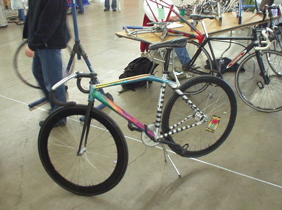 A fixed gear bike with a cool paint job.