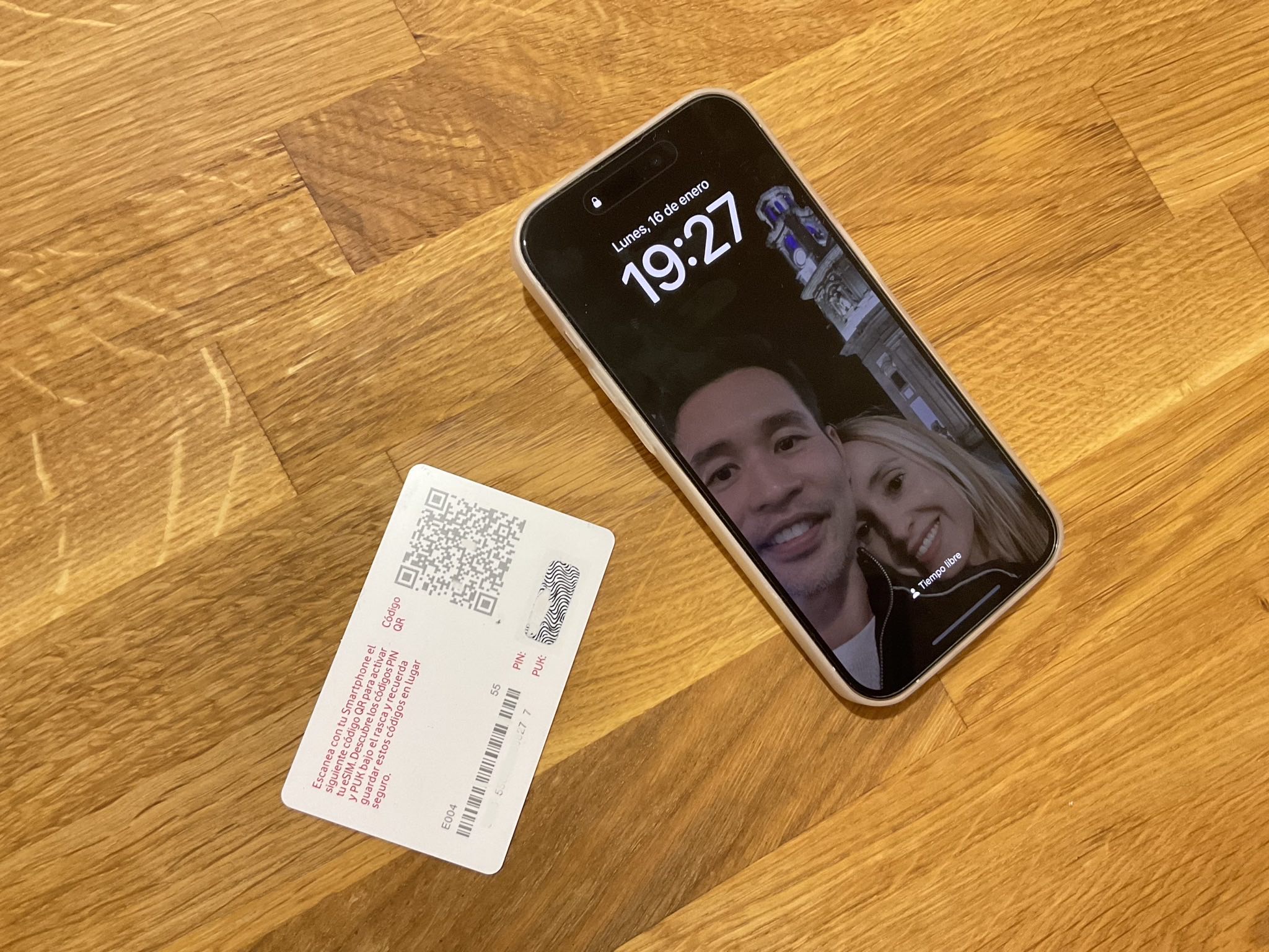 A Vodafone pre-paid eSIM card with QR code and an iPhone 14 Pro.